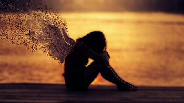 Facing Our Shortcomings from a Place of Love a young woman with wings sitting with her head on her arms